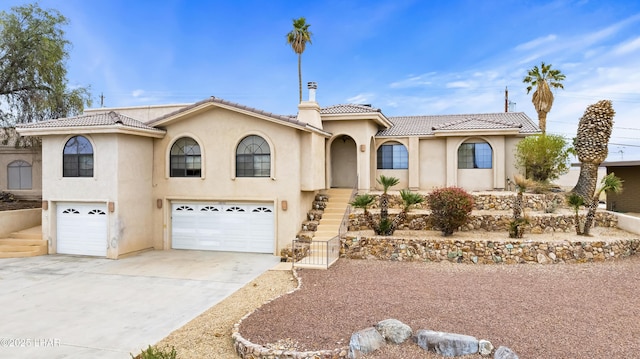 mediterranean / spanish home with a garage