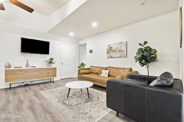 living room with ceiling fan and light wood-type flooring