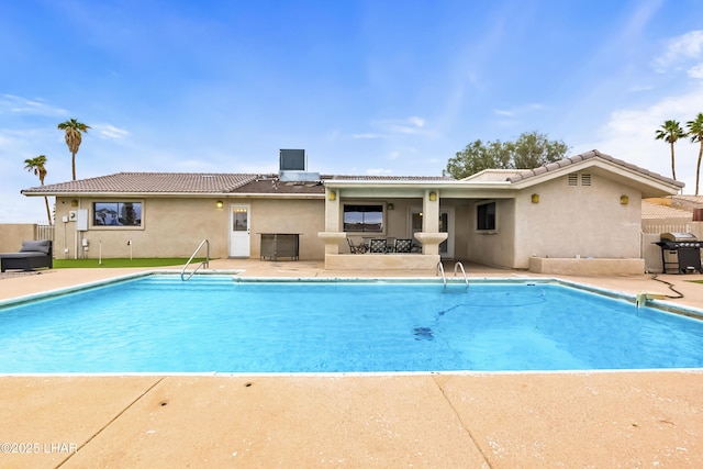 view of swimming pool with area for grilling and a patio area