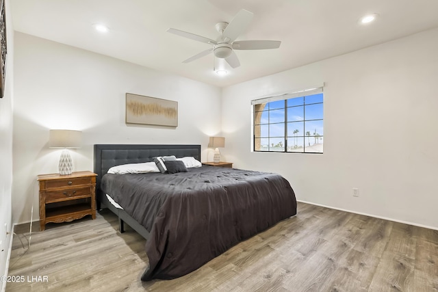 bedroom with ceiling fan and light hardwood / wood-style floors