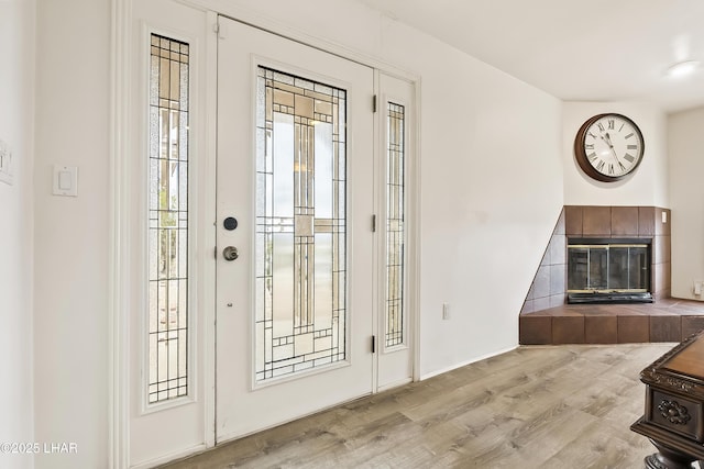 entryway featuring a fireplace and light hardwood / wood-style floors