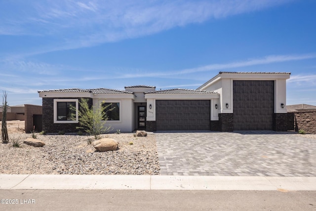 1650 E Sandra Dr, Lake Havasu City, AZ 86404 - view of front facade featuring an attached garage, decorative driveway, a tile roof, and stucco siding