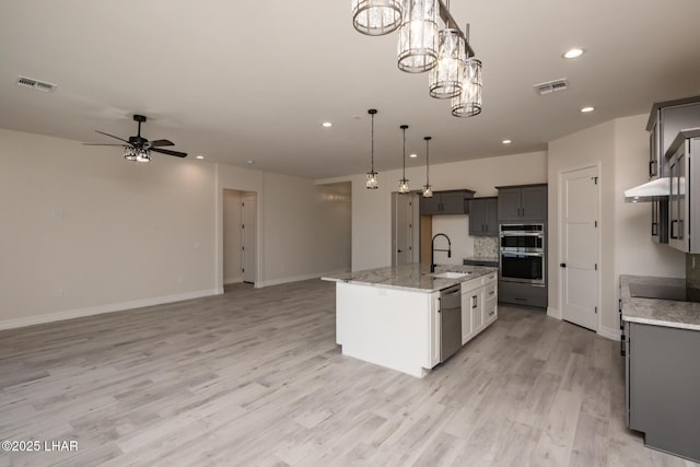 1650 E Sandra Dr, Lake Havasu City, AZ 86404 - kitchen featuring appliances with stainless steel finishes, a sink, open floor plan, a ceiling fan, and hanging light fixtures