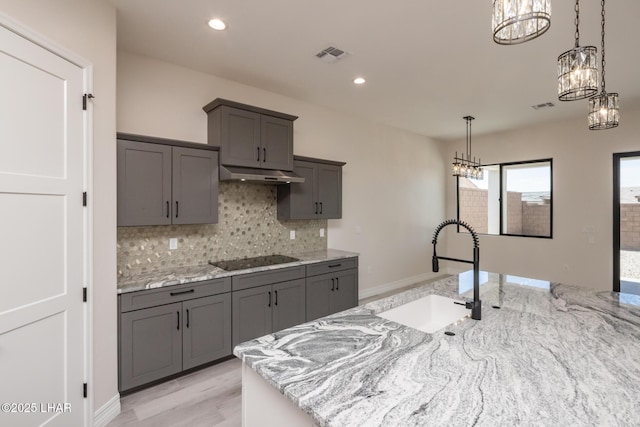 1650 E Sandra Dr, Lake Havasu City, AZ 86404 - kitchen featuring a sink, black electric cooktop, under cabinet range hood, a chandelier, and recessed lighting