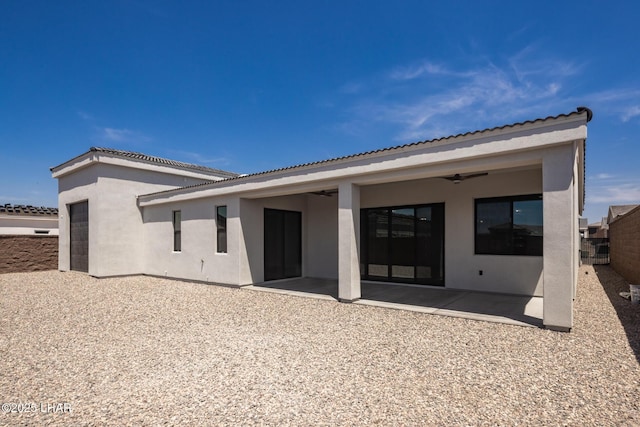 1650 E Sandra Dr, Lake Havasu City, AZ 86404 - rear view of house featuring ceiling fan, a patio area, stucco siding, a garage, and a tiled roof