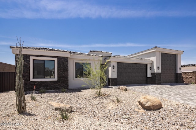 1650 E Sandra Dr, Lake Havasu City, AZ 86404 - view of front of home featuring an attached garage, decorative driveway, a tiled roof, and stucco siding