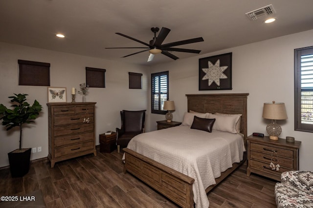 bedroom featuring ceiling fan, baseboards, dark wood-type flooring, visible vents, and recessed lighting
