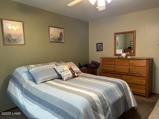 carpeted bedroom featuring ceiling fan