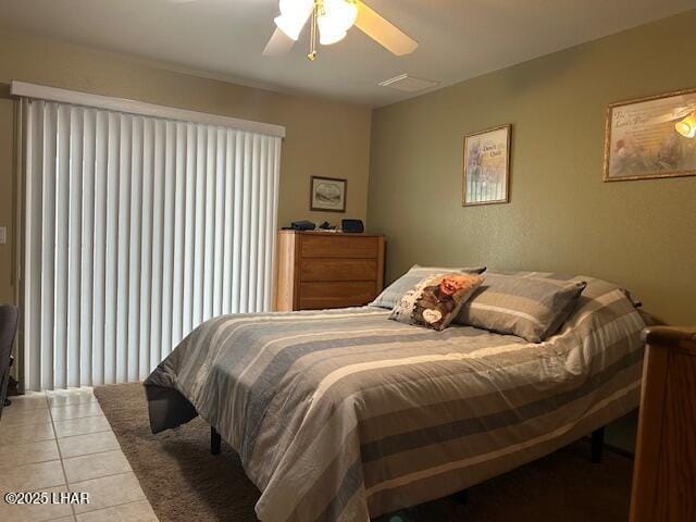 bedroom featuring light tile patterned flooring and ceiling fan