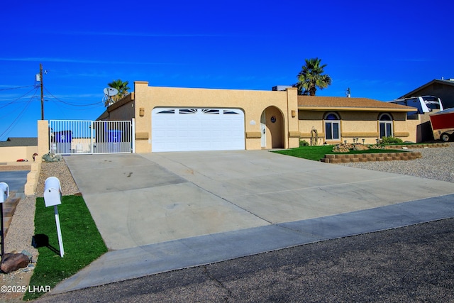 view of front of property with driveway, an attached garage, and stucco siding