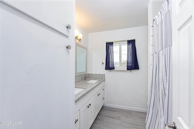 1880 Biscayne Ln, Lake Havasu City, AZ 86403 - full bathroom with double vanity, a sink, baseboards, and wood finished floors