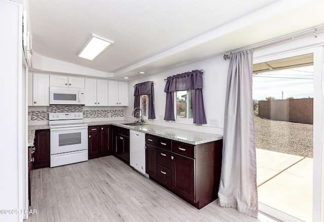 1880 Biscayne Ln, Lake Havasu City, AZ 86403 - kitchen with a sink, white appliances, white cabinets, light wood-style floors, and decorative backsplash