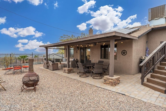 view of patio / terrace featuring central AC unit and a fire pit