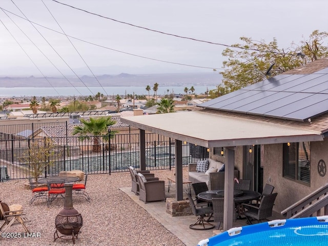 view of patio / terrace with a mountain view, a fire pit, and a swimming pool