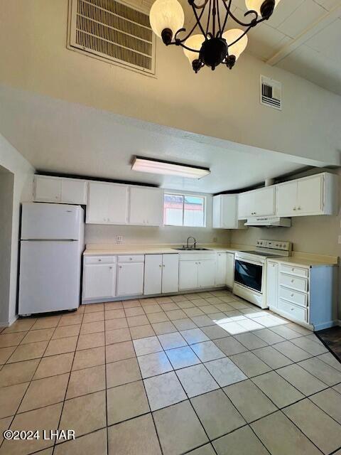 kitchen featuring sink, white appliances, light tile patterned floors, white cabinetry, and hanging light fixtures