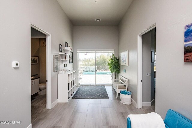 interior space with light wood-style floors, visible vents, and baseboards