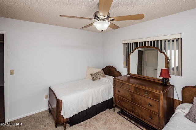 tiled bedroom with ceiling fan and a textured ceiling