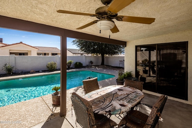 view of pool featuring ceiling fan and a patio