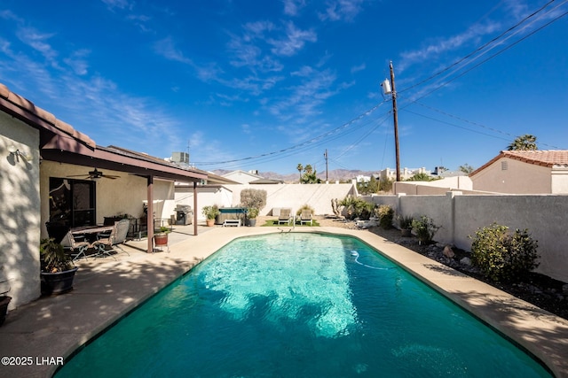 view of pool featuring ceiling fan and a patio area