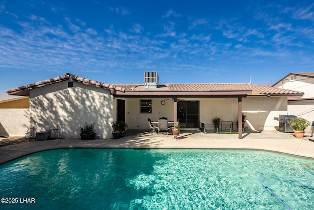 back of property featuring central AC and a patio