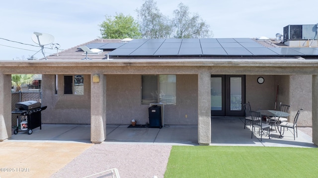 2780 Shasta Ln, Lake Havasu City, AZ 86403 - rear view of house with cooling unit, stucco siding, french doors, roof mounted solar panels, and a patio area