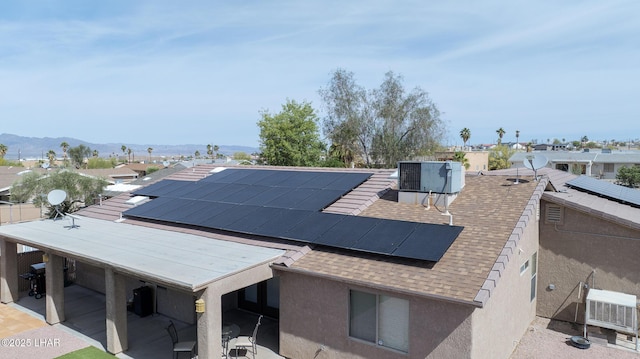 2780 Shasta Ln, Lake Havasu City, AZ 86403 - details with stucco siding, roof with shingles, central air condition unit, and a mountain view