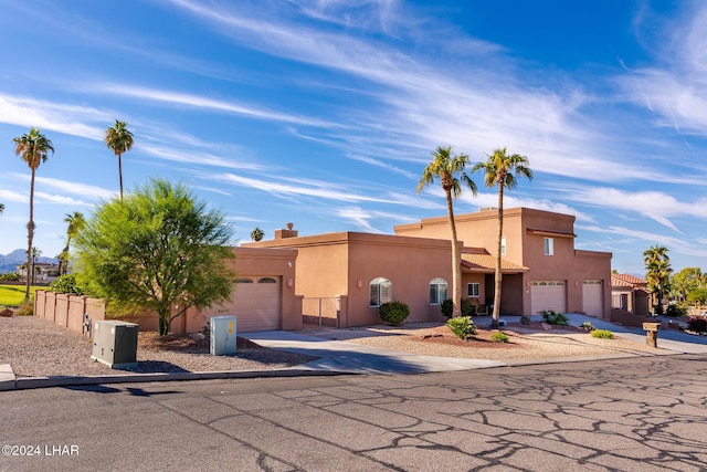 pueblo-style home with a garage