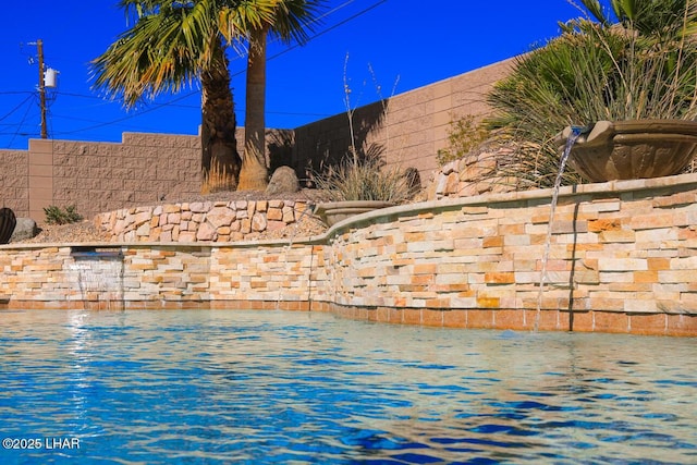 view of swimming pool with a fenced backyard