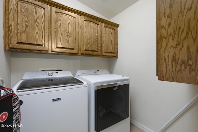 laundry area with cabinet space, baseboards, and separate washer and dryer