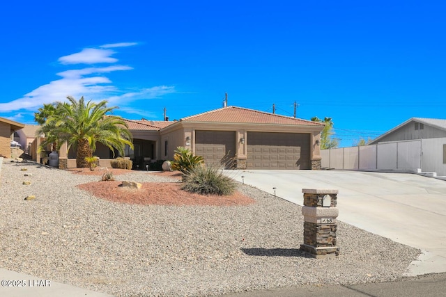 view of front of home featuring an attached garage, a tiled roof, concrete driveway, stone siding, and stucco siding