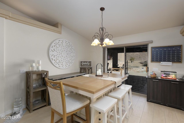 dining space featuring vaulted ceiling and a chandelier