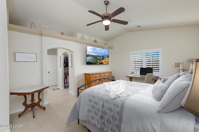 bedroom featuring ceiling fan, visible vents, arched walkways, and vaulted ceiling