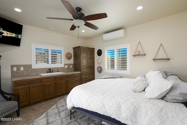 bedroom featuring ceiling fan, recessed lighting, a sink, a wall mounted AC, and tile patterned floors