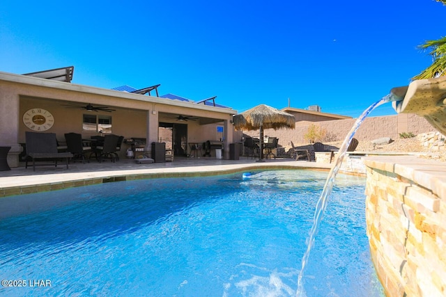 view of swimming pool featuring ceiling fan, a patio, fence, and a fenced in pool