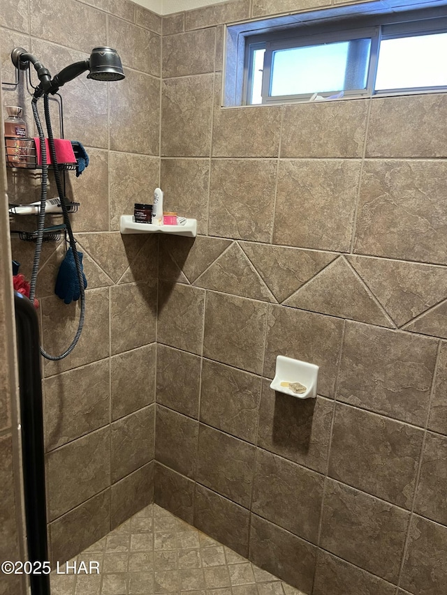 bathroom with a tile shower