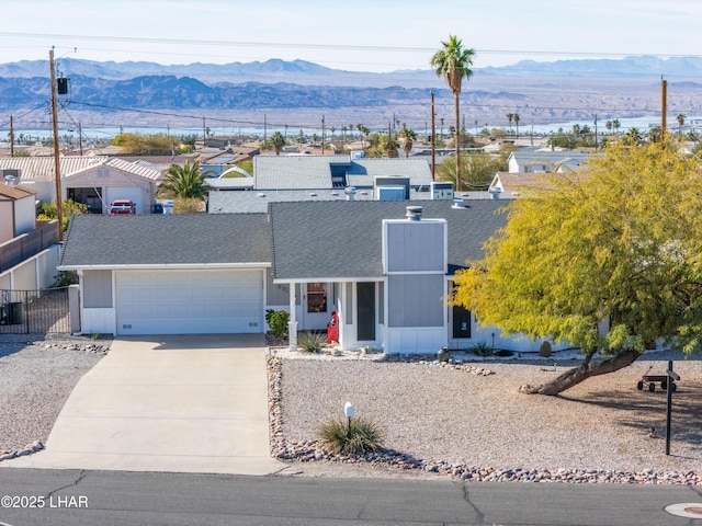 single story home featuring a mountain view and a garage