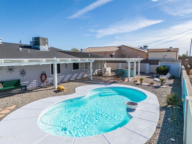 view of swimming pool featuring a hot tub, central AC, a patio area, and a pergola