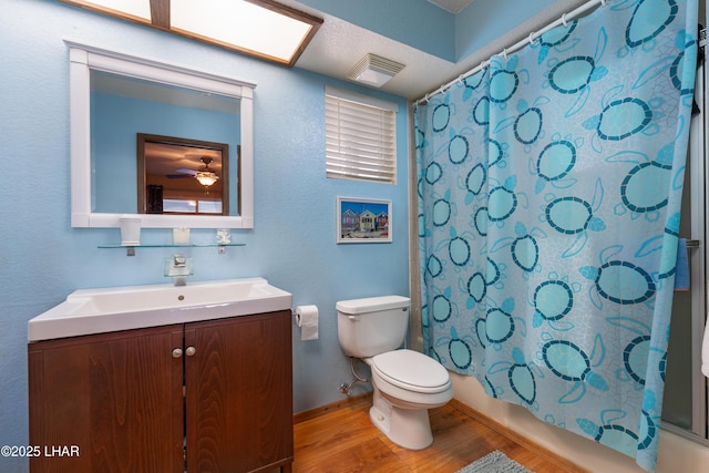 full bathroom featuring vanity, toilet, shower / tub combo, and hardwood / wood-style floors