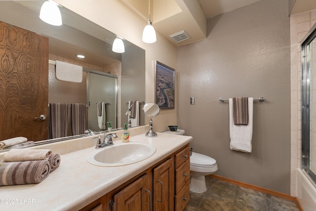 full bathroom featuring enclosed tub / shower combo, vanity, and toilet