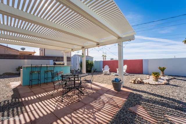 view of patio featuring a pergola, an outdoor bar, and a storage shed