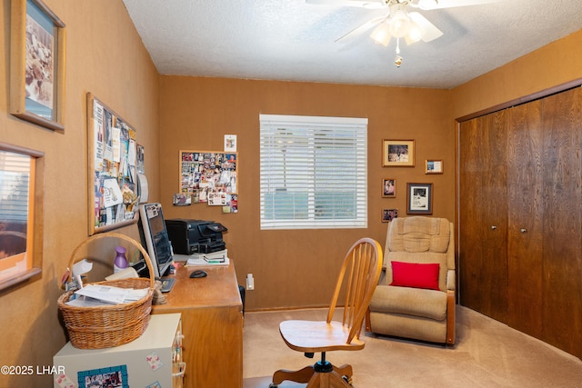 office area with ceiling fan, a textured ceiling, and carpet flooring