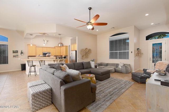 living area featuring light tile patterned floors, ceiling fan, and recessed lighting