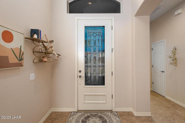 entrance foyer featuring tile patterned flooring and baseboards