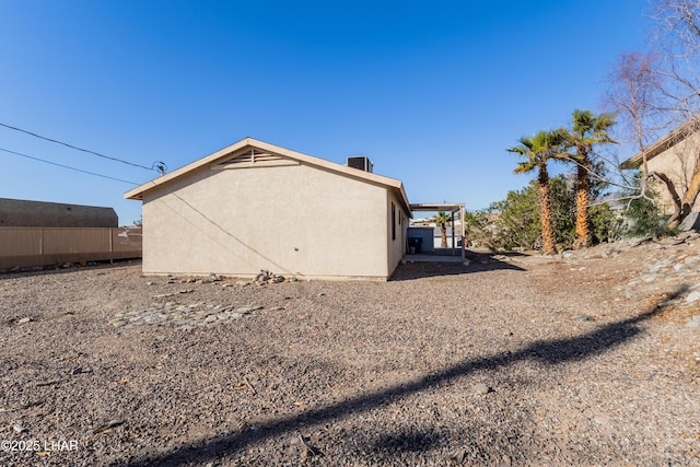 view of side of home featuring stucco siding and central air condition unit