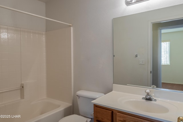 bathroom featuring vanity, shower / tub combination, and toilet