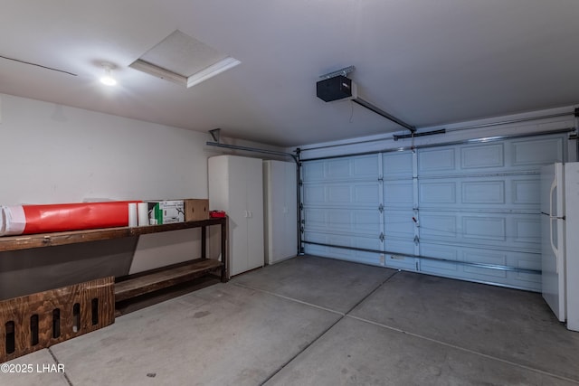 garage with a garage door opener and freestanding refrigerator