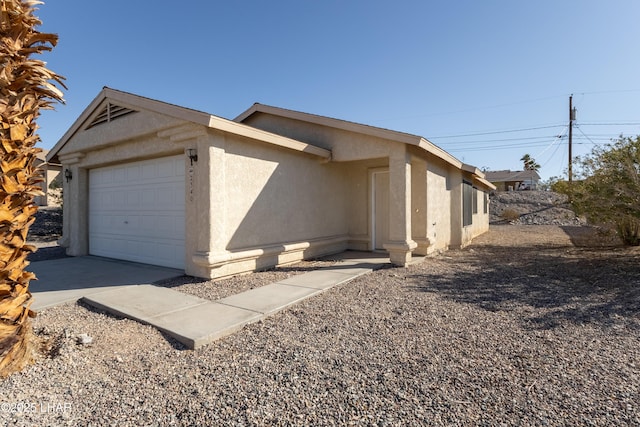 view of front of house with a garage and stucco siding