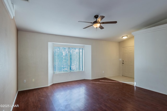 unfurnished room with baseboards, wood finished floors, and a ceiling fan