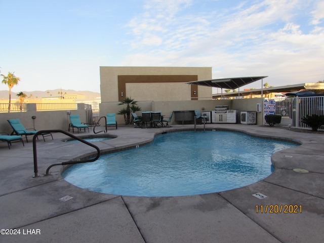 view of swimming pool with a patio area and an outdoor kitchen