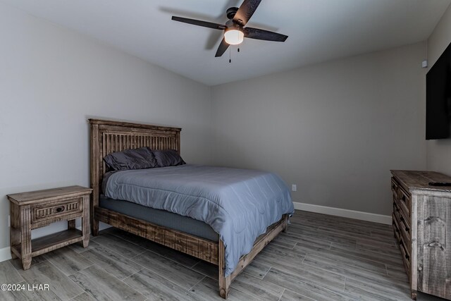 bedroom featuring light hardwood / wood-style flooring and ceiling fan